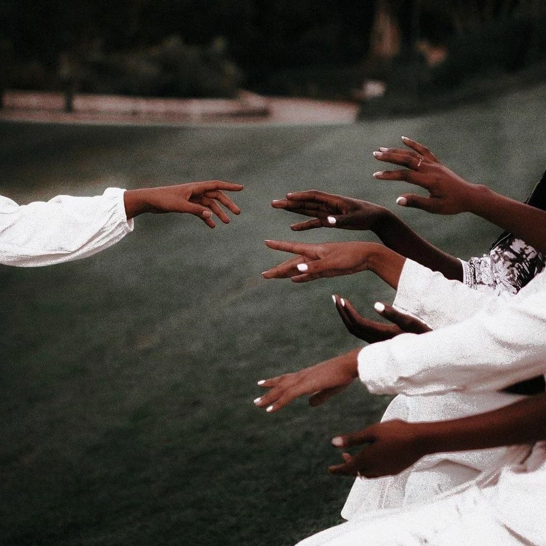 Multiple hands joined together in unity